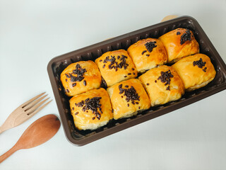 Banana cake or bolen sprinkled with chocolate sprinkles isolated on white background