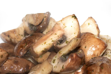 Close Up of a Chopped and Fried Cooked Chestnut Mushroom with Parsley Herb on White Background