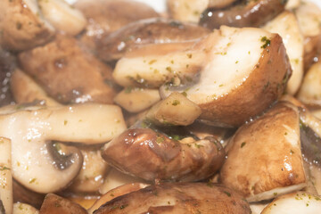 Close Up of a Chopped and Fried Cooked Chestnut Mushroom with Parsley Herb on White Background