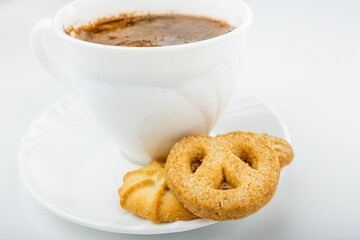 Danish cookies on a white background with coffee in a white cup, freshly brewed American coffee, isolate, breakfast, pastries, delicious shortbread cookies, catalog photo of food, coffee in bed