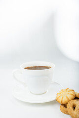 Danish cookies on a white background with coffee in a white cup, freshly brewed American coffee, isolate, breakfast, pastries, delicious shortbread cookies, catalog photo of food, coffee in bed