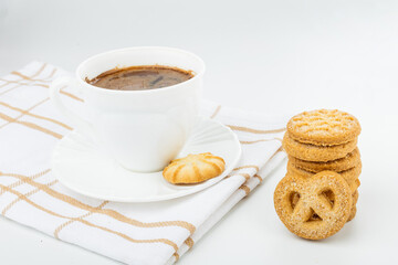 Danish cookies on a white background with coffee in a white cup, freshly brewed American coffee, isolate, breakfast, pastries, delicious shortbread cookies, catalog photo of food, coffee in bed