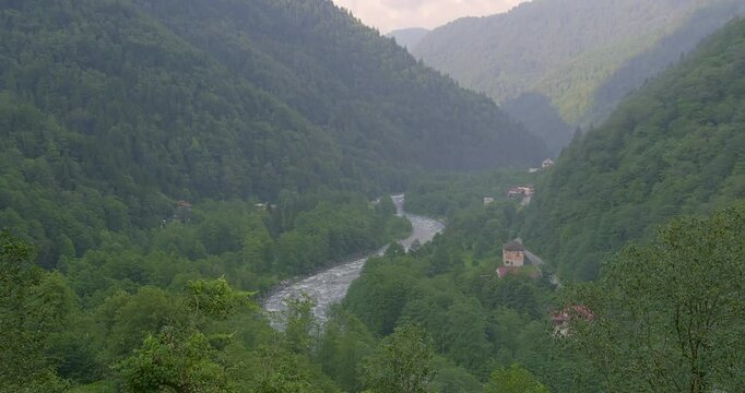 A breathtaking view of the Kackar Mountains in Rize, Turkey, covered in lush green forests and misty valleys. A serene and majestic natural landscape
