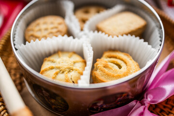 shortbread Danish cookies, red candle, red and pink silk ribbons, Valentine's Day, romantic atmosphere, Valentine's Day gift, delicious dessert for the holiday, tea cookies
