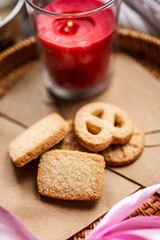 shortbread Danish cookies, red candle, red and pink silk ribbons, Valentine's Day, romantic atmosphere, Valentine's Day gift, delicious dessert for the holiday, tea cookies