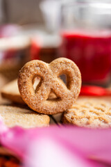 shortbread Danish cookies, red candle, red and pink silk ribbons, Valentine's Day, romantic atmosphere, Valentine's Day gift, delicious dessert for the holiday, tea cookies