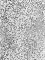 Cracked white paint forming abstract texture background