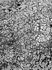 Old cracked paint forming abstract pattern on a flat surface