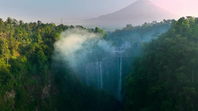 Tumpak Sewu Waterfall and Semeru mountain Waterfall in deep tropical forest. Beautiful forest in the morning. Bali, indonesia