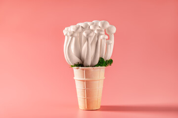 shimeji mushrooms with green moss in green ice cream cone, on pink background