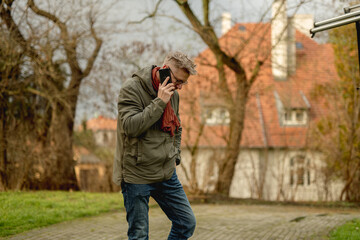 Young, Attractive Man On A Street Using Smartphone