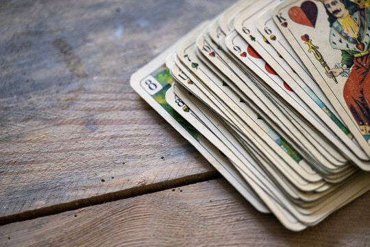 Vintage Spielkarten und Lederetui auf rustikaler Holzoberfl&auml;che