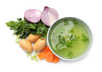 Tasty chicken bouillon in bowl and ingredients isolated on white, top view