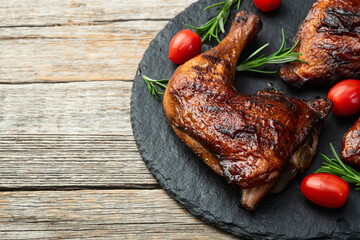 Grilled chicken legs with tomatoes and salad . Top view