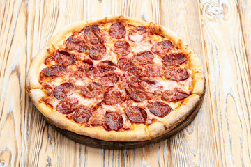 Pizza pepperoni fast food . Top view on rustic background