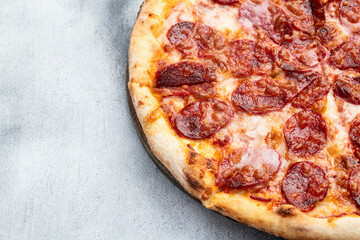 Pizza pepperoni fast food . Top view on rustic background