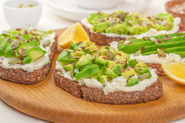 toast with avocado and cheese. Food recipe background. Close up. Clean eating, dieting, vegan food concept