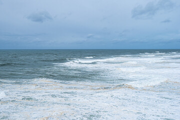 Big waves near the lighthouse at Praia do Norte, Nazare, Portugal