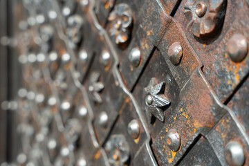 A metal object with a star and flower design. The design is intricate and detailed, with many small stars and flowers scattered throughout the piece. Scene is one of elegance and sophistication