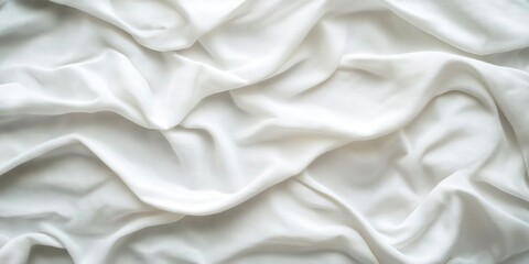 Fototapeta premium Textured background of soft focus wrinkled white bedding sheets with gentle creases and ample copy space, highlighting smooth fabric layers.