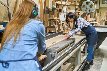 Young apprentices learning woodworking skills in a bustling workshop