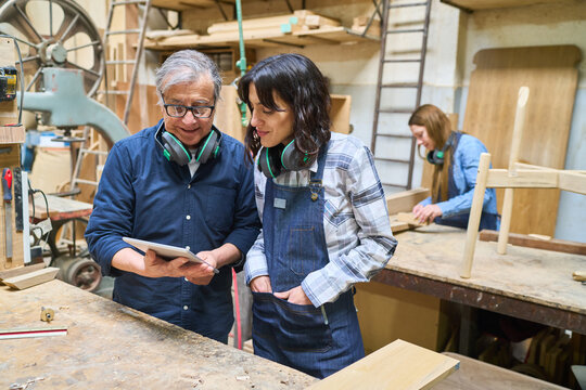 Teamwork in a busy lumberyard with mixed generation workers