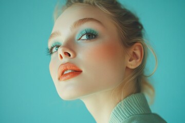 Fashionable young scandinavian woman with stylish mint makeup on blue background 