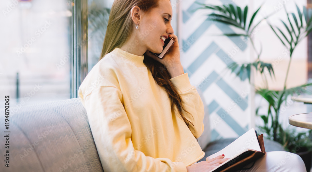 Aufkleber happy woman holding textbook and calling to operator for online customer consultancy via cellphone d