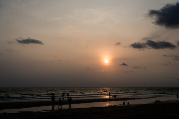 Fototapeta premium Landscape with sea sunset on the beach with family playing water at Thailand