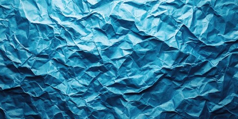 Fototapeta premium Crumpled paper texture in vibrant shades of blue creates an oceanic background with varied depth and ample copy space for design versatility