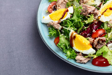 Canned Tuna salad with eggs and tomatoes photography . Top view