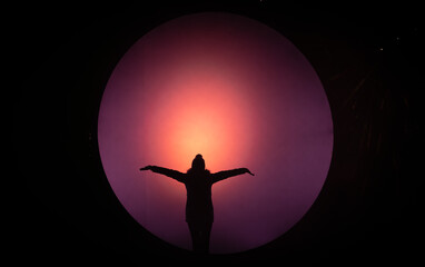 Woman in winter clothing highlighted in a light globe