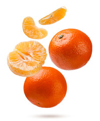 Tangerines, mandarin halves and slices fly close-up on a white background. Isolated