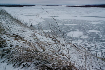 frozen river and high bank in winter