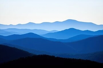 Fototapeta premium Mountain Range Gradient: Mountains in silhouette with a gradient sky from dark blue at the peak to a light blue at the base