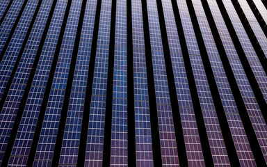 Aerial Drone View of a Solar Energy Farm in a Field.