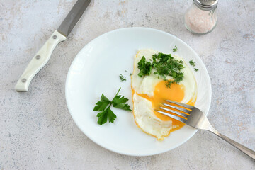 an egg with yellow yolk on the plate flat lay
