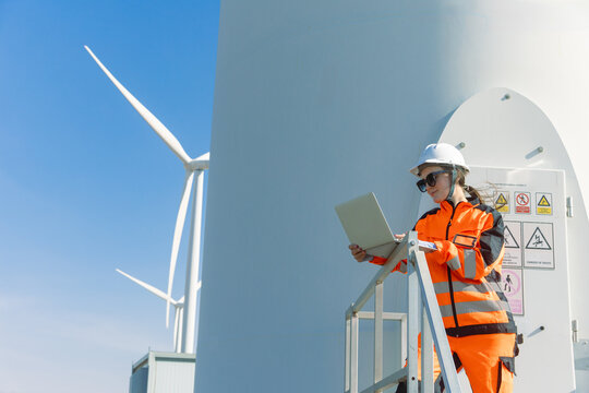 Engineer technician worker checking service maintenance wind turbine clean electricity power station