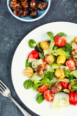 Green salad with tomato and seasonal herbs and roasted chestnuts.