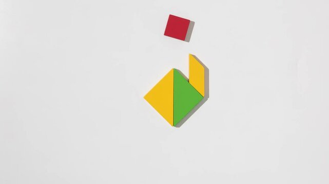 Colorful wooden tangram puzzle pieces forming a bird shape on a white background
