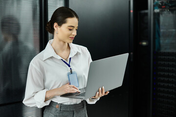 An IT specialist in a white shirt works diligently to ensure system security in a server room.