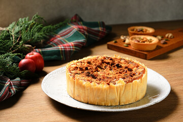 Apple crumb pie on a wooden table background. Apple crumble pie dessert, sweet and crunch with christmas ambient