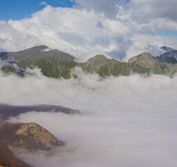 winter snowbound mountain valley in dense mist and clouds