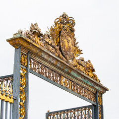 Versailles Castle gate detail. Gilded historical golden castle gate in Versailles, France.