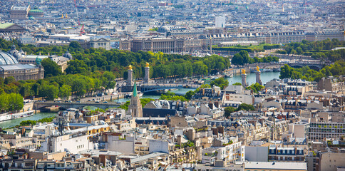 The Bridge Pont Alexandre III and the surrounding buildings viewed from the Eiffel Tower in a sunny summer day.