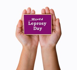 Hands hold Purple background with World Leprosy Day text written. 