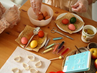 Female hands holding colored Easter eggs. Easter. Trappings