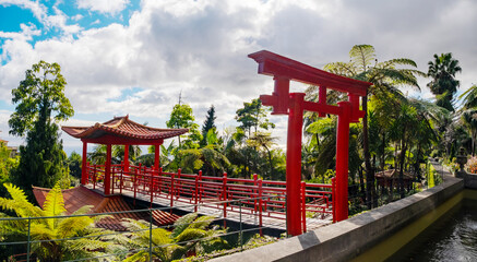 Monte Palace tropical garden with red pagoda, lakes and traditional buildings above the city of Funchal, popular tourist destination in Madeira island, Portugal