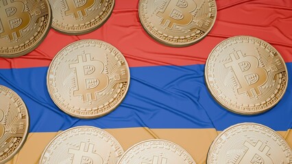 Several bitcoins are laid out on the flag of Armenia