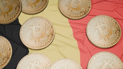 Several bitcoins are laid out on the flag of Belgium